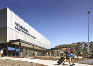 Wiigulga Multipurpose Centre outdoor signage during daytime with clear skies and visitors.